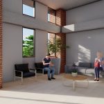 Dos personas se sientan en una habitación moderna e iluminada por el sol, con paredes de ladrillo, grandes ventanales, un sofá gris, dos sillas negras, una mesa de centro redonda y una maceta, con vegetación visible en el exterior.