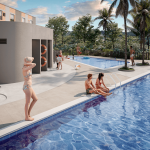 La gente se relaja y socializa alrededor de la moderna piscina exterior de Villabosque Nativo, rodeada de palmeras. Algunos toman el sol, otros nadan o utilizan las duchas exteriores cercanas en esta escena luminosa y veraniega.