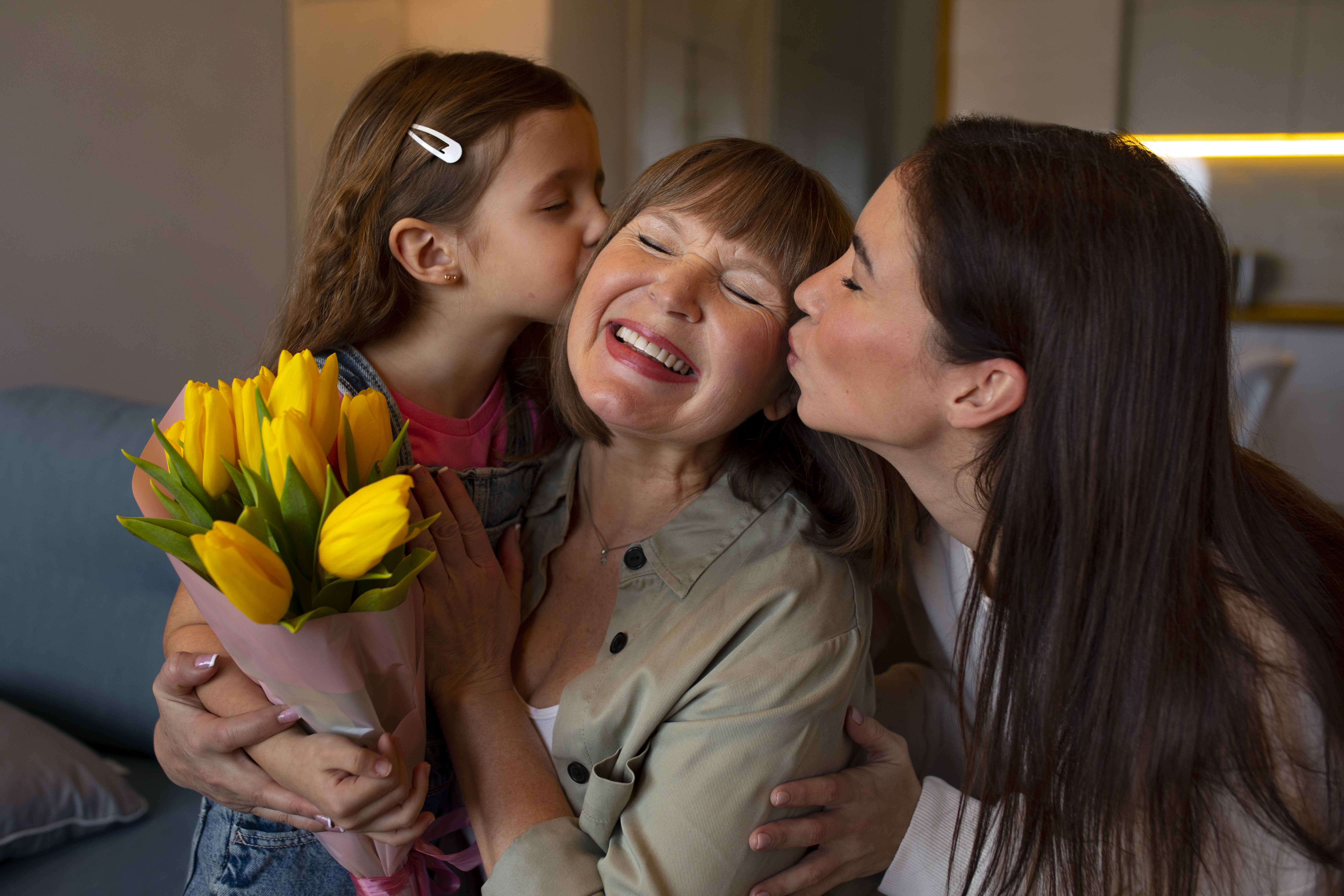 grandmother-being-kissed-cheek-by-family