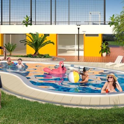 Cinco personas disfrutan de una piscina en el patio trasero; un hombre está de pie en la hierba tomándose un selfie, mientras los demás se relajan en flotadores de piscina y en el agua junto a un moderno edificio amarillo de Entreguaduas, rodeado de exuberante vegetación.